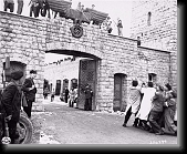Survivors eagerly pull down the Nazi eagle over entrance to the Mauthausen concentration camp. * 453 x 370 * (76KB)